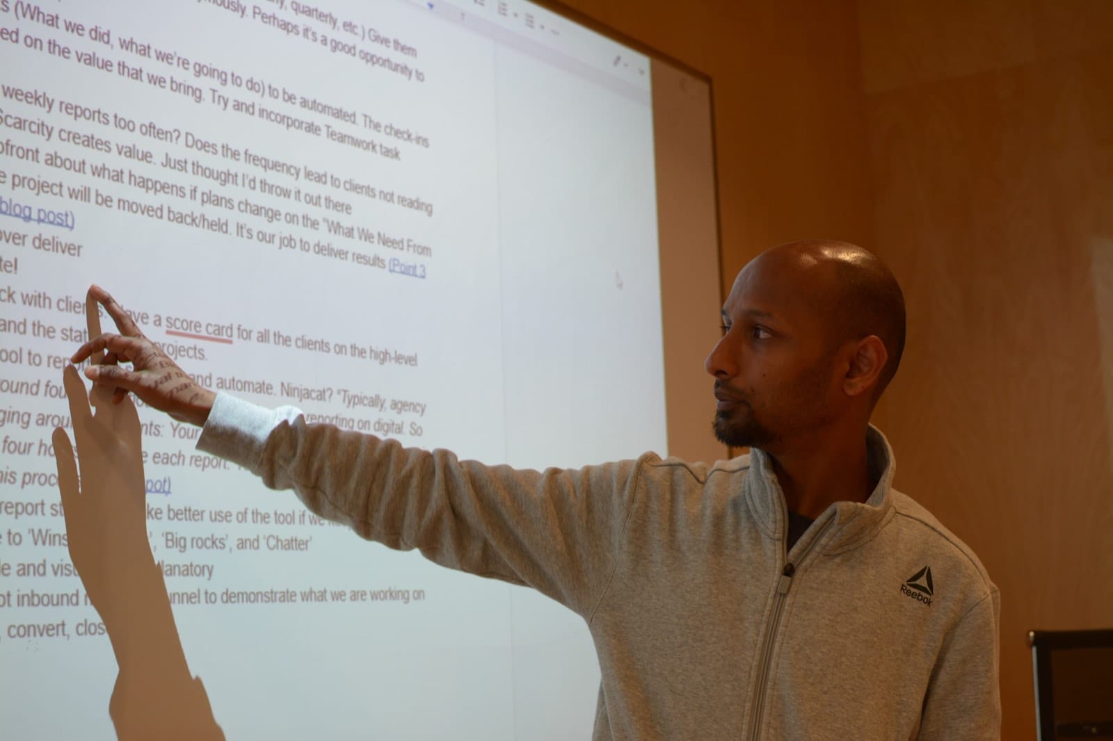 Vikram Shivahare walking a team through a marketing plan on a whiteboard